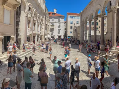 Split, Croatia, 8-6-2021: Tourists crowd the square in front of Diocletian's palace.