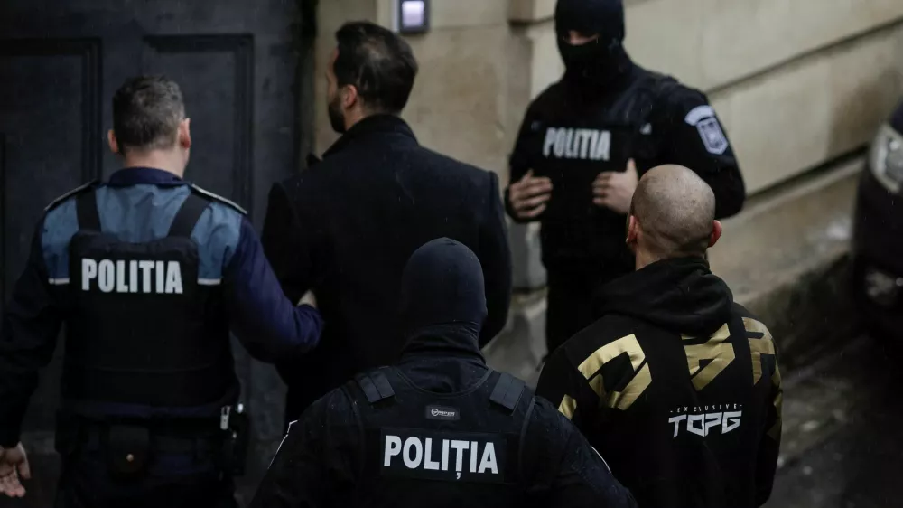 Tristan Tate and Andrew Tate are brought in by police officers to appear in front of a judge at the Bucharest Court of Appeal, in Bucharest, Romania, March 12, 2024. Inquam Photos/Octav Ganea via REUTERS ATTENTION EDITORS - THIS IMAGE WAS PROVIDED BY A THIRD PARTY. ROMANIA OUT. NO COMMERCIAL OR EDITORIAL SALES IN ROMANIA