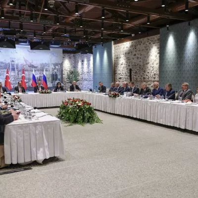 In this handout photo released by Turkish Foreign Ministry, Turkish Foreign Minister Hakan Fidan, center, chairs a meeting between delegations from Russia, right, and Ukraine, left, at Dolmabahce palace in Istanbul, Turkey, Friday, May 16, 2025. (Murat Gok/Turkish Foreign Ministry via AP)