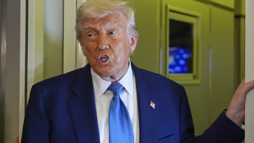 President Donald Trump speaks on Air Force One at Abu Dhabi International Airport before departing, Friday, May 16, 2025, in Abu Dhabi, United Arab Emirates. (AP Photo/Alex Brandon)