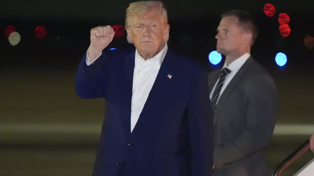 President Donald Trump gestures as he arrives on Air Force One, Friday, May 16, 2025, at Joint Base Andrews, Md. (AP Photo/Alex Brandon)