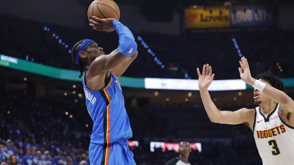 May 18, 2025; Oklahoma City, Oklahoma, USA; Oklahoma City Thunder guard Shai Gilgeous-Alexander (2) shoots as Denver Nuggets guard Julian Strawther (3) defends in the second half of game seven of the second round for the 2025 NBA Playoffs at Paycom Center. Mandatory Credit: Alonzo Adams-Imagn Images