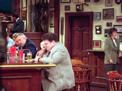 George Wendt, right, who portrays Norm Peterson sheds a tear on the set of the popular NBC series, "Cheers," as John Ratzenberger, portraying Cliff Calvin, looks away during a scene while taping the final episode in Los Angeles, Calif., on April 1, 1993. (AP Photo/Mark J. Terrill)