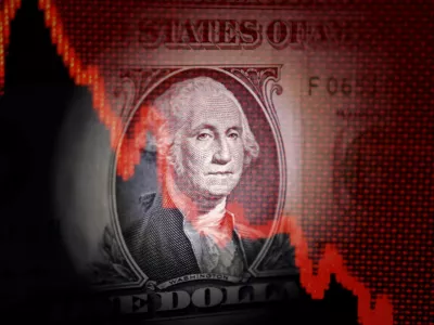 FILE PHOTO: U.S. dollar banknote and decreasing stock graph are seen in this illustration taken April 25, 2025. REUTERS/Dado Ruvic/Illustration/File Photo