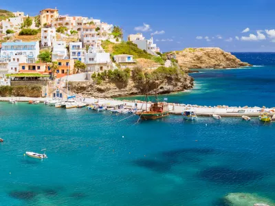 Harbour with marine vessels, boats and lighthouse. Panoramic view from a cliff on a Bay with a beach and architecture Bali - vacation destination resort, with secluded beaches and clear turquoise ocean waters, Rethymno, Crete, Greece