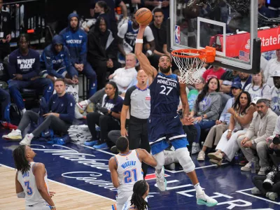 May 24, 2025; Minneapolis, Minnesota, USA; Minnesota Timberwolves center Rudy Gobert (27) goes in for a dunk against Oklahoma City Thunder guard Aaron Wiggins (21) during the second half in game three of the western conference finals for the 2025 NBA Playoffs at Target Center. Mandatory Credit: Brad Rempel-Imagn Images