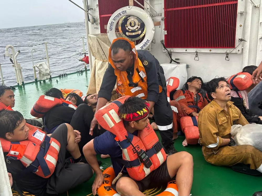Crew members of a Liberian-flagged container vessel MSC ELSA 3 sit after they were rescued off Kerala Coast, India, May 24, 2025. India's Press Information Bureau/Handout via REUTERS THIS IMAGE HAS BEEN SUPPLIED BY A THIRD PARTY. NO RESALES. NO ARCHIVES.