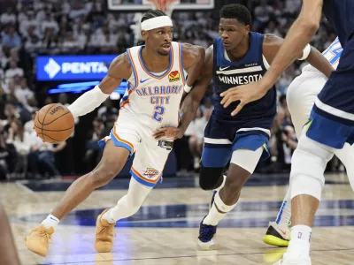 Oklahoma City Thunder guard Shai Gilgeous-Alexander (2) drives to the basket against Minnesota Timberwolves guard Anthony Edwards during the first half of Game 4 of the Western Conference finals of the NBA basketball playoffs Monday, May 26, 2025, in Minneapolis. (AP Photo/Abbie Parr)
