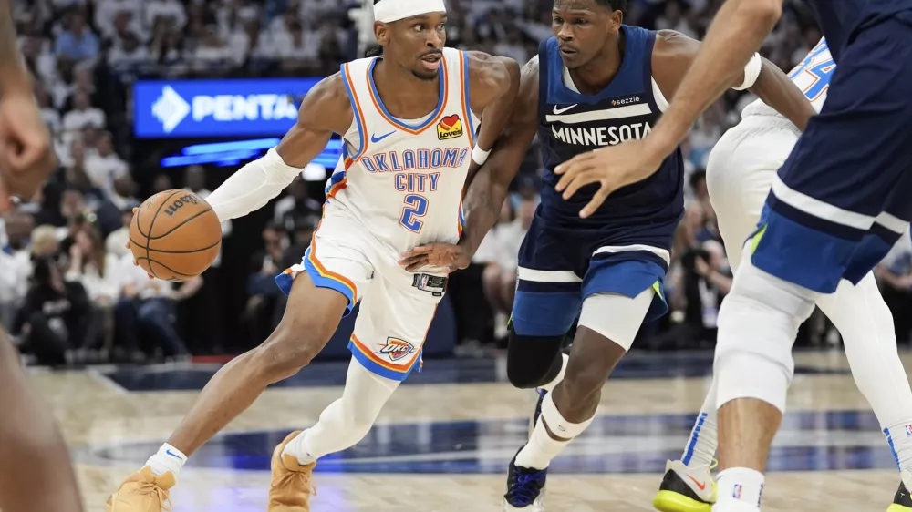 Oklahoma City Thunder guard Shai Gilgeous-Alexander (2) drives to the basket against Minnesota Timberwolves guard Anthony Edwards during the first half of Game 4 of the Western Conference finals of the NBA basketball playoffs Monday, May 26, 2025, in Minneapolis. (AP Photo/Abbie Parr)