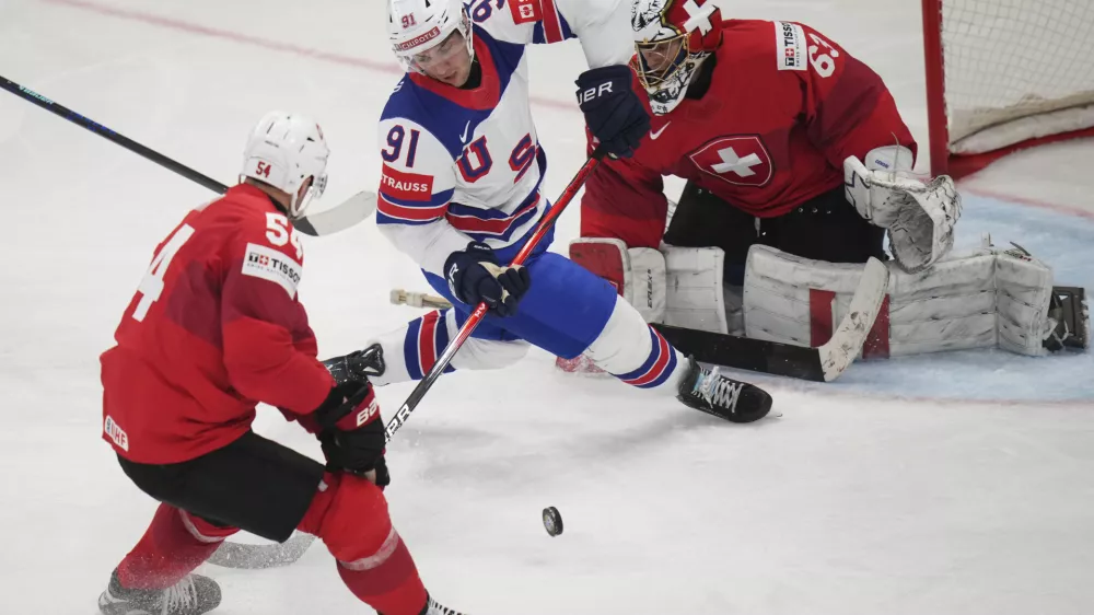 United States' Frank Nazar falls between Switzerland's Christian Marti and goalkeeper Leonardo Genoni during the final match between United States and Switzerland at the ice hockey world championships in Stockholm, Sweden, Sunday, May 25, 2025. (AP Photo/Petr David Josek)