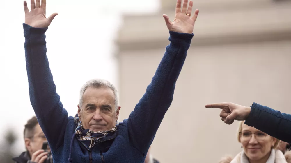 FILE - Calin Georgescu, the winner of the first round of presidential elections, later annulled by the Constitutional Court, waves to supporters during a protest, in Bucharest, Romania, March 1, 2025. (AP Photo/Vadim Ghirda, File)