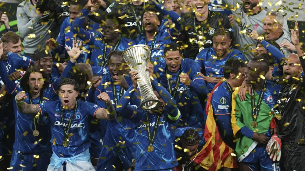 Chelsea's Reece James holds the trophy as he celebrates with his teammates after winning the Europa Conference League final soccer match between Real Betis and Chelsea in Wroclaw, Poland, Wednesday, May 28, 2025. (AP Photo/Darko Vojinovic)