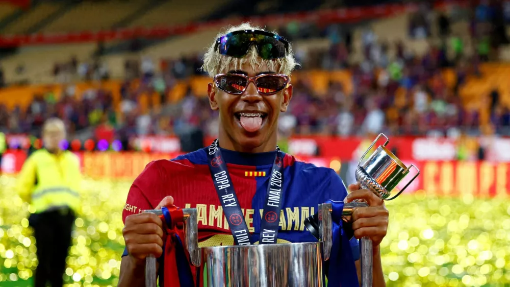 FILE PHOTO: Soccer Football - Copa del Rey - Final - FC Barcelona v Real Madrid - Estadio de La Cartuja, Seville, Spain - April 26, 2025 FC Barcelona's Lamine Yamal celebrates with the trophy after winning the Copa del Rey REUTERS/Borja Suarez/File Photo