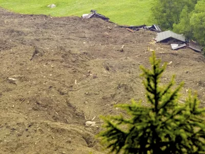 A large avalanche with a mixture of ice, rock, snow and water reach the valley floor is pictured in Wiler after the Birch glacier collapsing above Blatten, Switzerland, Wednesday, May 28, 2025. (Jean-Christophe Bott/Keystone via AP)