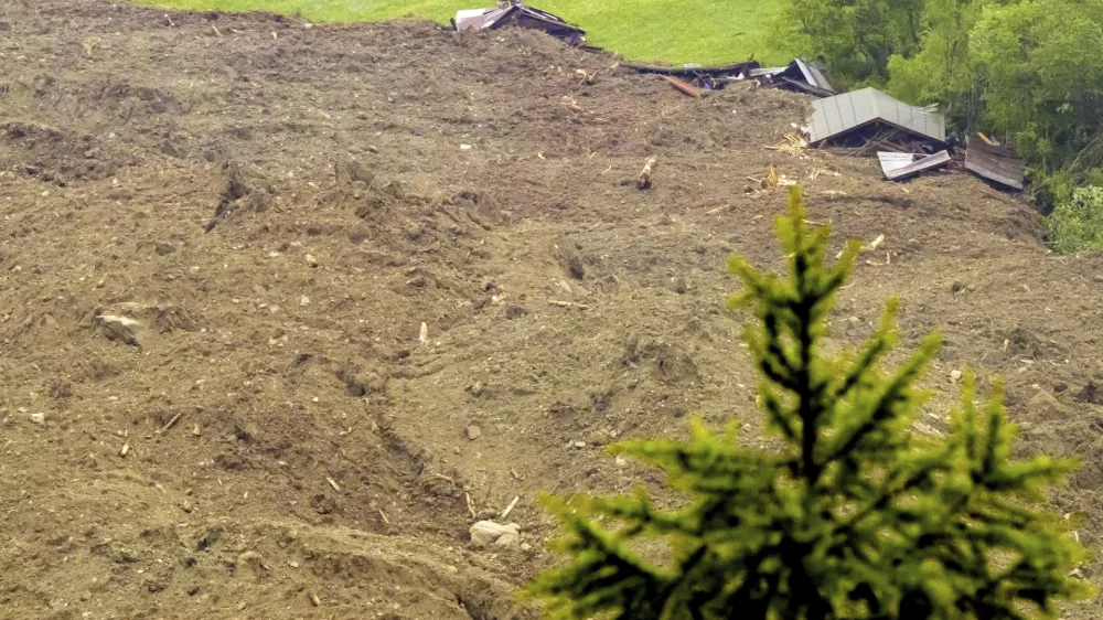 A large avalanche with a mixture of ice, rock, snow and water reach the valley floor is pictured in Wiler after the Birch glacier collapsing above Blatten, Switzerland, Wednesday, May 28, 2025. (Jean-Christophe Bott/Keystone via AP)