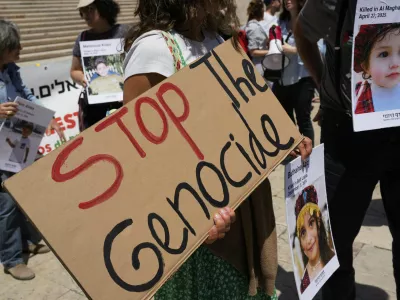 Protestors hold pictures of Palestinian children killed in Gaza during a demonstration organized by Israeli citizens demanding action from the European Union against the government of Israel to stop the war, outside the Portuguese parliament in Lisbon, Tuesday, May 27, 2025. (AP Photo/Armando Franca)