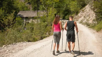 Active young couple on a hike in forest on a hot wummer day