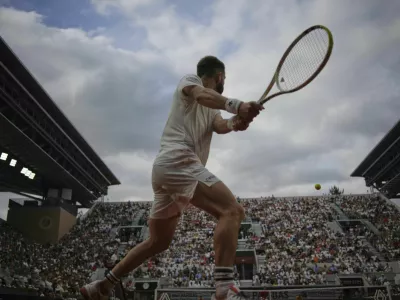 France's Corentin Moutet returns the ball to Serbia's Novak Djokovic during their second round match of the French Tennis Open, at the Roland-Garros stadium, in Paris, Thursday, May 29, 2025. (AP Photo/Christophe Ena)