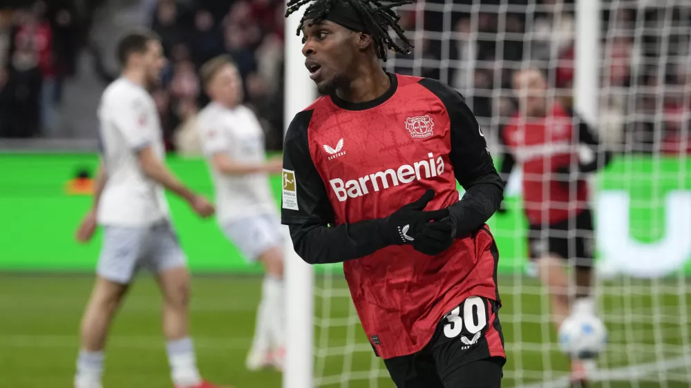 FILE - Leverkusen's Jeremie Frimpong celebrates after he scored his side's second goal during the German Bundesliga soccer match between Bayer Leverkusen and TSG Hoffenheim at the BayArena in Leverkusen, Germany, Sunday, Feb. 2, 2025. (AP Photo/Martin Meissner, File)