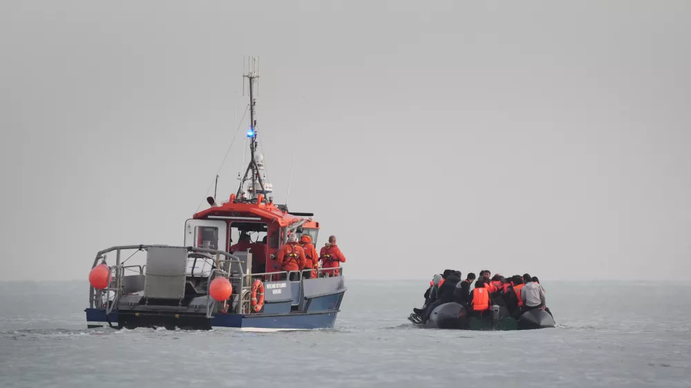 31 May 2025, France, Gravelines: French authorities escort people thought to be migrants onboard a small boat leaving the beach at Gravelines, France, in an attempt to reach the UK by crossing the English Channel. Photo: Gareth Fuller/PA Wire/dpa