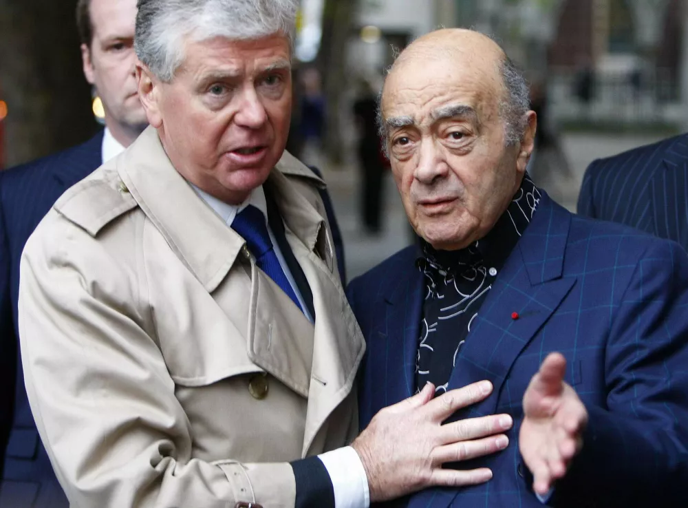 Mohamed al-Fayed (R) talks to the media outside the Royal Courts of Justice in London October 2, 2007. An inquest into the death of Princess Diana finally opened on Tuesday, 10 years after she was killed in a Paris car crash, with her lover's father still convinced the pair were victims of an Establishment plot.    REUTERS/Kieran Doherty  (BRITAIN)