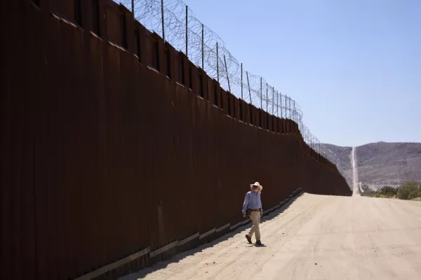 Volunteer Sam Schultz walks along a stretch of empty high desert where, in years past, he would sometimes see hundreds of migrants daily crossing the border separating Mexico and the United States, Thursday, June 5, 2025, near Jacumba Hot Springs, Calif. (AP Photo/Gregory Bull)