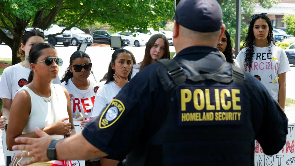 A Homeland Security officer speaks to classmates and relatives gathered outside the Immigration court as an immigration judge held a bond hearing for Marcelo Gomes da Silva, a high school student from Milford who was detained by Immigration and Enforcement (ICE), in Chelmsford, Massachusetts, U.S., June 5, 2025.  REUTERS/Brian Snyder