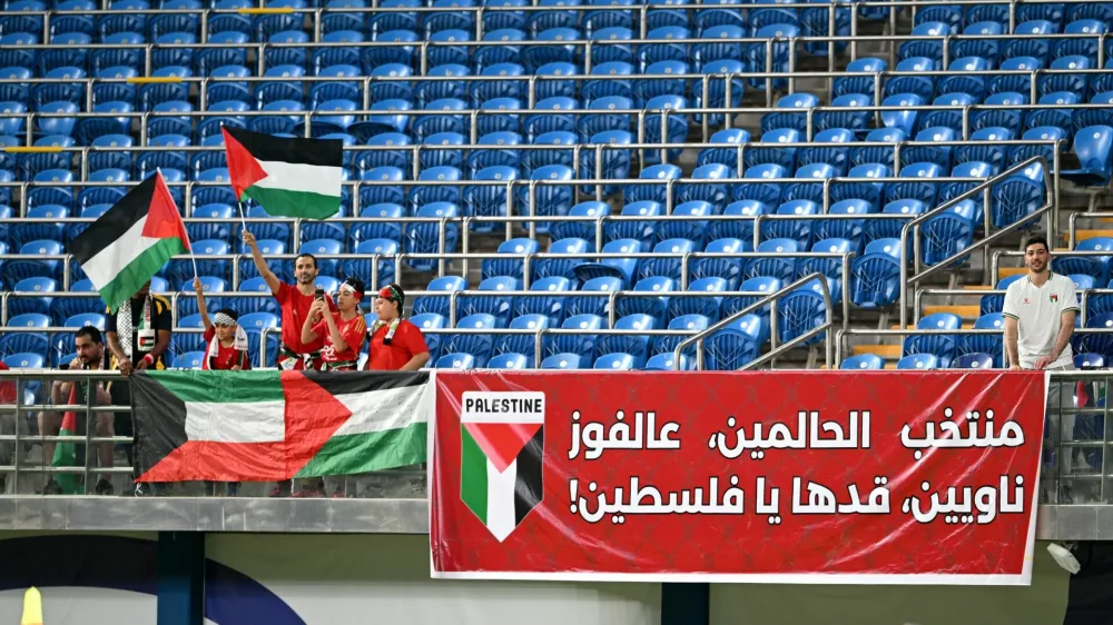 Soccer Football - World Cup - AFC Qualifiers - Group B - Kuwait v Palestine - Jaber Al-Ahmad International Stadium, Kuwait City, Kuwait - June 5, 2025 Palestine fans wave flags in the stands before the match REUTERS/Noufal Ibrahim