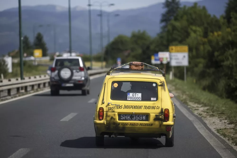 Tarik Fatic along with his brother Mirnes drives the Reliant Regal, an exact copy of the famous BBC TV show  "Only Fools and Horses" iconic yellow car in Sarajevo, Bosnia, Wednesday, June 4, 2025. (AP Photo/Armin Durgut)