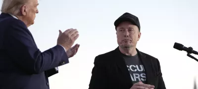 FILE - Republican presidential nominee former President Donald Trump, left, claps as Tesla and SpaceX CEO Elon Musk prepares to depart after a campaign event at the Butler Farm Show on Oct. 5, 2024, in Butler, Pa. (AP Photo/Alex Brandon, File)