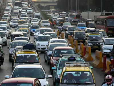 Traffic clogs a road in Mumbai, India, Friday, Dec. 5, 2014. India says it is taking bold steps against climate change with plans for a five-fold increase in renewable energy capacity. However, Environment Minister Prakash Javadekar said the country won't act to curb carbon emissions because it first must pursue economic growth to eradicate poverty. (AP Photo/Rajanish Kakade)