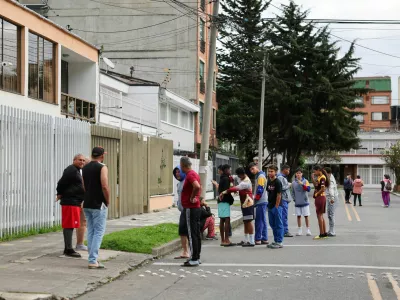 People stand on a street, in the aftermath of an earthquake, in Bogota, Colombia, June 8, 2025. REUTERS/Luisa Gonzalez