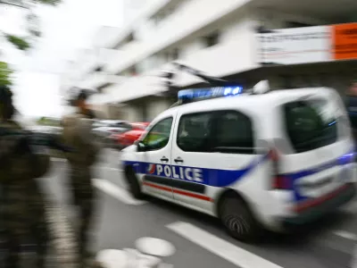 24 April 2025, France, Nantes: A police car drives to the Notre-Dame de Toutes-Aides secondary school, where one pupil has been killed and three others injured in a knife attack. Photo: Loic Venance/AFP/dpa