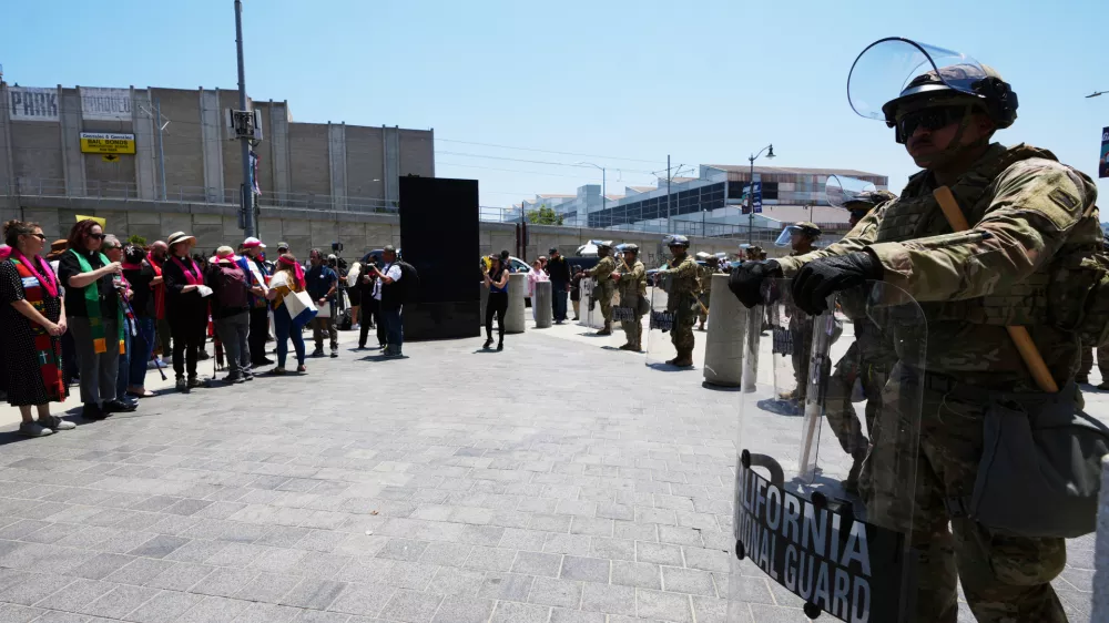 U.S. National Guard stand by as protesters gather to denounce ICE, U.S Immigration and Customs Enforcement, operations Tuesday, June 10, 2025, in Los Angeles. (AP Photo Damian Dovarganes)