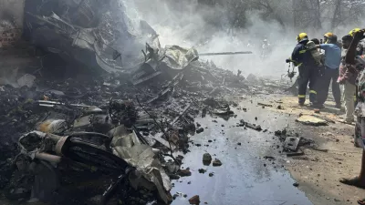 Firefighters work at the site of an airplane that crashed in India's northwestern city of Ahmedabad in Gujarat state, Thursday, June12, 2025. (AP Photo/Ajit Solanki)