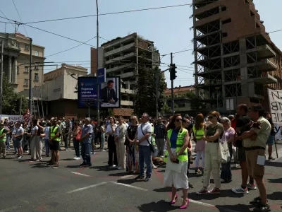 University students and other people stand in silence to commemorate the 16 victims, who were killed after a railway concrete canopy fell in November 2024 in Novi Sad, during a protest against government pressure on the universities, in front of a government building, in Belgrade, Serbia, June 9, 2025. REUTERS/Zorana Jevtic