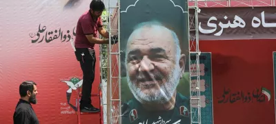 A man installs a banner with a picture of late Islamic Revolutionary Guard Corps (IRGC) Commander-in-Chief Major General Hossein Salami, following the Israeli strikes on Iran, in Tehran, June 14, 2025. Majid Asgaripour/WANA (West Asia News Agency) via REUTERS  ATTENTION EDITORS - THIS PICTURE WAS PROVIDED BY A THIRD PARTY.   TPX IMAGES OF THE DAY