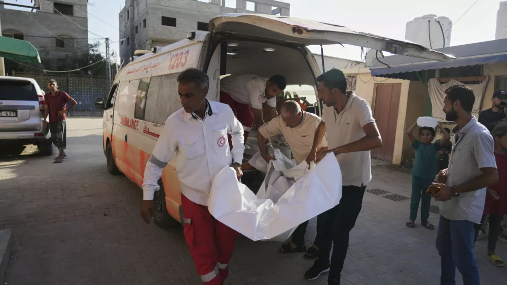 Palestinians who were killed in an Israeli army airstrike are brought to Al-Aqsa Hospital in Deir al-Balah, Gaza Strip, Saturday, June 14, 2025. (AP Photo/Abdel Kareem Hana)