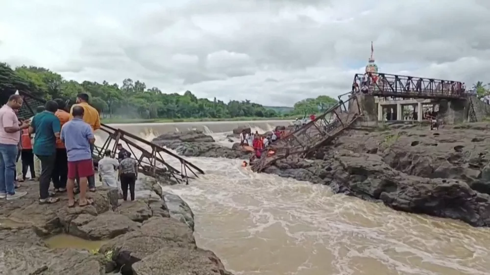 People gather following a bridge collapse over the Indrayani river in the western Indian city, in Pune, India, June 15, 2025, in this still image taken from a video. ANI/Reuters TV via REUTERS  THIS IMAGE HAS BEEN SUPPLIED BY A THIRD PARTY. INDIA OUT. NO COMMERCIAL OR EDITORIAL SALES IN INDIA.