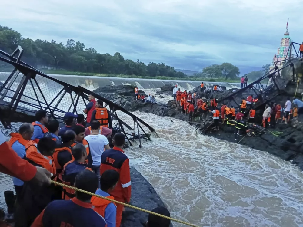 Rescuers work at the site of a bridge collapse near Pune, India, Sunday, June 15, 2025. (AP Photo)