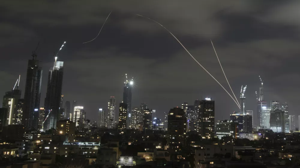 The Israeli Iron Dome air defense system fires to intercept missiles over Tel Aviv, Israel, Sunday, June 15, 2025. (AP Photo/Leo Correa)