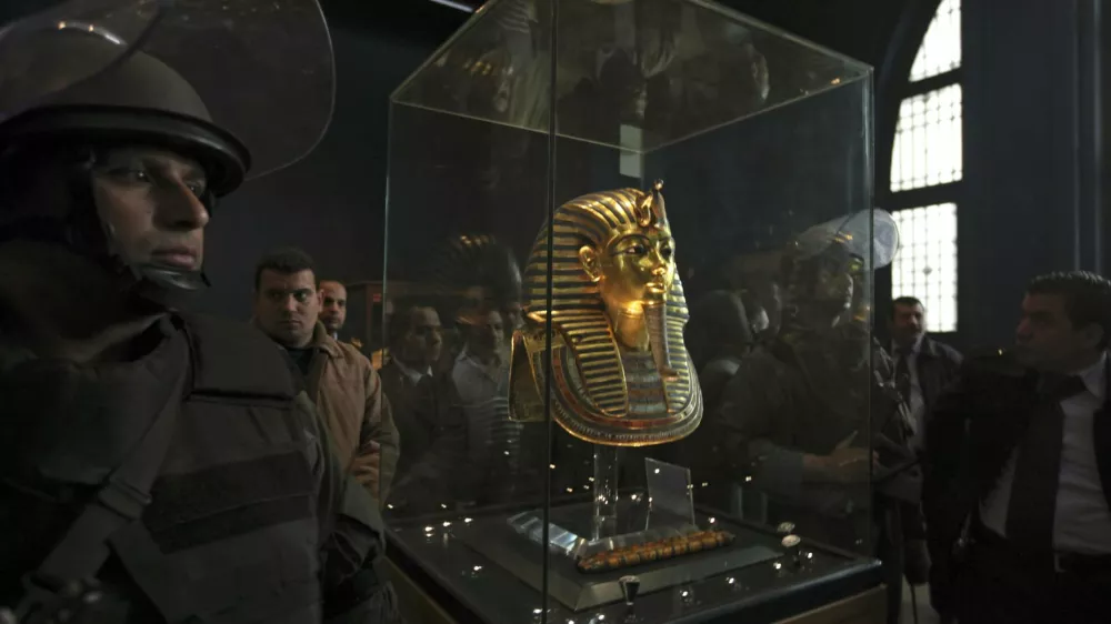 Army special forces stand next to the funeral mask of King Tutankhamun is seen in its glass case in the Egyptian Museum in Cairo, Egypt, Wednesday Feb. 16, 2011. Dr. Zahi Hawass, Director for the Supreme Council of Antiquities said that three of the 18 items reporting missing from Cairo's Egyptian Museum had been found. According to Hawass thieves entered the museum while the mass street protests that led to the ouster of former Egyptian President Hosni Mubarak. (AP Photo/Tara Todras-Whitehill)