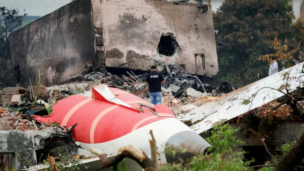 FILE PHOTO: FILE PHOTO: A fire officer stands next to the crashed Air India Boeing 787-8 Dreamliner aircraft, in Ahmedabad, India, June 13, 2025. REUTERS/Adnan Abidi/File Photo/File Photo