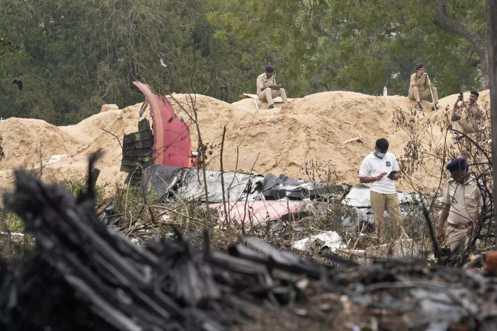 Police personnel work at the site of an Air India plane crash in Ahmedabad, India, Friday, June 13, 2025. (AP Photo/Rafiq Maqbool)
