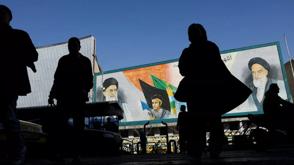 FILE PHOTO: People walk near a mural featuring images of Iran's Supreme Leader Ayatollah Ali Khamenei and leader of Iran's 1979 Islamic Revolution Ayatollah Ruhollah Khomeini, on a street in Tehran, Iran, February 17, 2026. Majid Asgaripour/WANA (West Asia News Agency) via REUTERS ATTENTION EDITORS - THIS PICTURE WAS PROVIDED BY A THIRD PARTY/File Photo