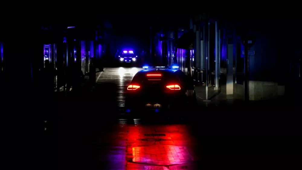 FILE PHOTO: Police car patrols a shopping street without electric lighting to prevent theft and looting in the stores during a power outage which hit large parts of Spain, in Ronda, Spain April 28, 2025. REUTERS/Jon Nazca/File Photo