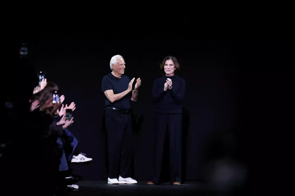 FILE PHOTO: Designer Giorgio Armani and Silvana Armani walk on stage after the Emporio Armani Fall/Winter 2025/2026 collection during Fashion Week in Milan, Italy, February 27, 2025. REUTERS/Claudia Greco/File Photo