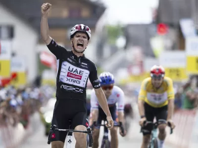 Joao Almeida of Portugal wins the seventh stage, a 207 km race from Neuhausen am Rheinfall to Emmetten, at the 88th Tour de Suisse UCI World Tour cycling race, Saturday, June 21, 2025. (Gian Ehrenzeller/Keystone via AP)