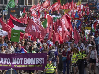 People carry banners and flags during a demonstration ahead of the NATO summit in The Hague, Netherlands, Sunday, June 22, 2025. (AP Photo/Peter Dejong)