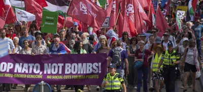 People carry banners and flags during a demonstration ahead of the NATO summit in The Hague, Netherlands, Sunday, June 22, 2025. (AP Photo/Peter Dejong)